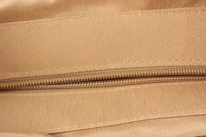 Detailed macro view of woven canvas fabric texture and high-quality zipper stitching