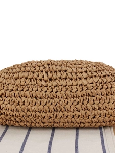 Fashionable khaki hand-woven straw bag for beach vacations with close-up texture
