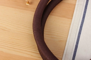 Macro shot of brown braided strap with spiral texture for handmade straw handbags