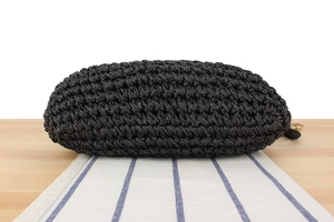 Detailed close-up showing the sturdy woven texture and solid base of the black crochet bag