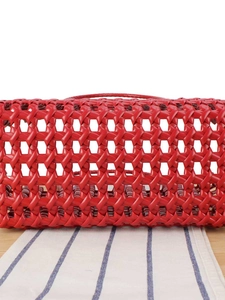 Vibrant red woven basket handbag featuring hollow-out design and sturdy top handles
