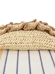 Handwoven straw clutch bag with scalloped edges for beach vacation and casual style