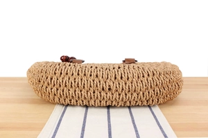 Detailed macro view of coarse woven straw texture with wooden beads and leather handles