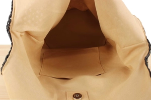 Internal view of woven tote bag with camel lining, pocket, and metal magnetic clasp