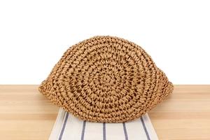 Close-up of handmade woven straw bag with natural plant fiber texture and spiral pattern