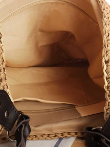 Spacious woven straw tote bag interior with coffee lining and a secure zipper pocket