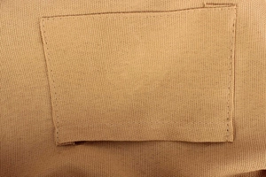 Detailed close-up of the internal canvas pocket and durable stitching of the tote bag