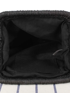 Minimalist black woven straw bag with fabric lining and internal pocket for beach vacation