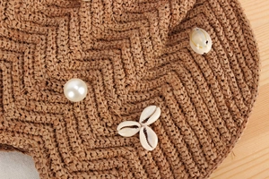 Macro view of woven raffia texture with pearl beads and seashell star details