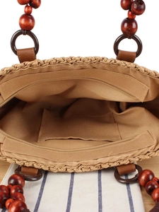 Handwoven straw handbag with inner zipper pocket, fabric lining and wooden bead handles