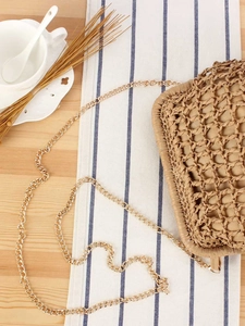 Woven straw clutch with gold chain strap for casual summer vacations and beach trips