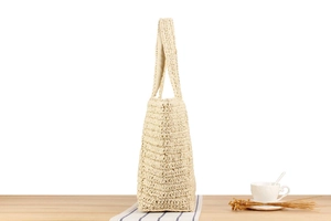 Close-up of woven straw tote bag texture and side view with cream fabric lining