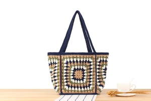 Detail of colorful crochet granny square tote bag with intricate handmade stitching