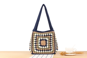 Detailed close-up of a hand-woven crochet tote with vintage granny square patterns