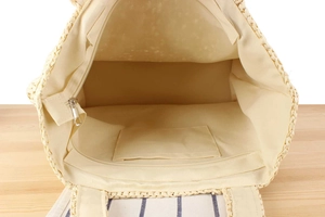 Detail view of woven tote bag interior with fabric lining, inner pocket and metal zipper