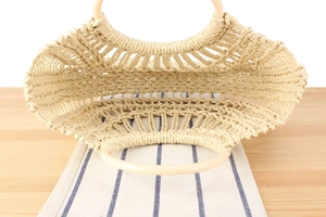 Top view showing the hollow woven texture and interior of the beige straw tote bag