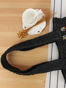 Handmade black woven paper straw bag with colorful bead circle and wide strap