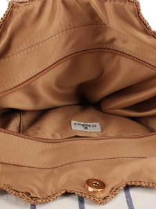 Interior of handmade raffia woven bag with magnetic clasp and zippered pocket detail