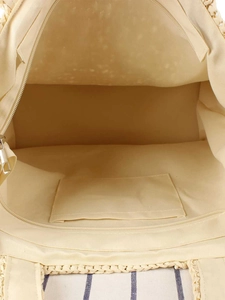 Spacious beige woven tote bag interior with a smooth fabric lining and secure zipper pocket