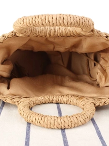 Handwoven straw tote bag with round top handles and drawstring lining for beach vacation