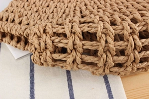 Macro shot of natural woven paper straw texture on a handmade summer beach bag