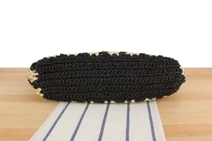 Detailed base view of striped beach bag showing black and beige woven structure