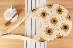 Detailed view of handmade sunflower crochet tote bag with intricate cotton knit textures