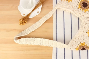 Detailed view of handmade woven tote bag with yellow sunflower patterns and cotton straps
