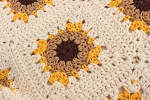 Macro view of woven sunflower pattern detail on high-quality handmade cotton crochet bag