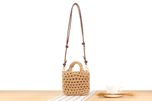 Detail of handmade cotton rope crochet bag in khaki and beige with deep brown straps