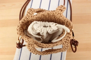 Top view of handmade woven cotton bucket bag with canvas liner and leather shoulder strap