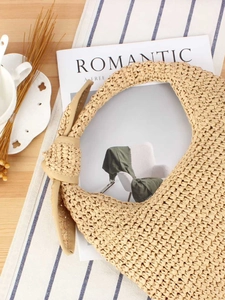 Handcrafted beige straw hobo bag with unique woven knot handle for beach vacation leisure
