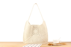 Close-up of handmade cotton weave shoulder bag featuring intricate circular crochet patterns
