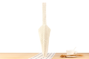 Detail of white handmade crochet shoulder bag side view with braided cotton cord texture