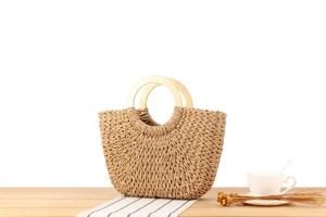 Detail der handgewebten Papiersacktasche mit runden Holzgriffen und strukturierter Webart