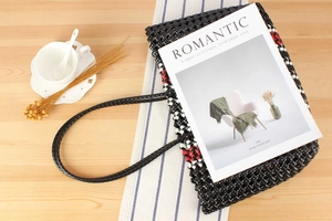 Detail of hand-woven picnic basket featuring black white and red plaid mesh pattern