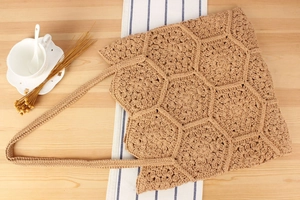 Macro detail of handmade crochet tote bag featuring khaki floral hexagon knit patterns