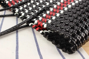 Close-up of woven picnic basket showing detailed black, red and white pattern texture