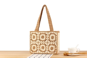 Detail of hand-crocheted grandmother square floral pattern on a cotton tote bag