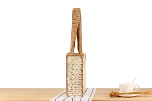 Detail of cream and brown crochet tote bag with textured knit pattern and strap