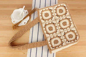 Detail of hand-crocheted floral mandala pattern on a beige bohemian cotton tote bag