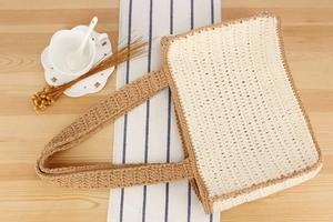 Top-down view of handmade crochet tote bag with woven texture on a rustic table