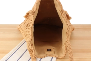Detail of the woven bag interior featuring fabric lining and metal magnetic closure