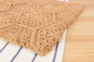 Detail of handmade cotton woven bag with hexagonal honeycomb knit texture in natural brown
