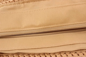 Close-up of durable zipper closure and smooth fabric lining on the handmade crochet tote bag