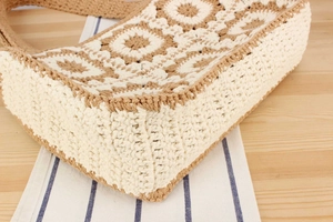 Detailed view of handmade crochet tote with geometric floral knit and cream-brown patterns