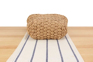Close-up of the woven texture on a natural straw beach bag with fine craftsmanship