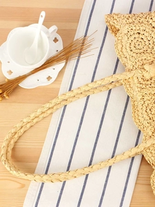 Handcrafted straw woven bag in natural wood color for summer beach vacation and daily use
