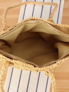 Handcrafted woven straw tote bag with zipper closure and natural wood-colored finish