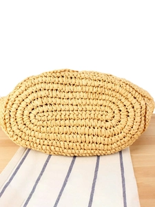 Handcrafted beige straw woven bag with reinforced oval base for summer vacation